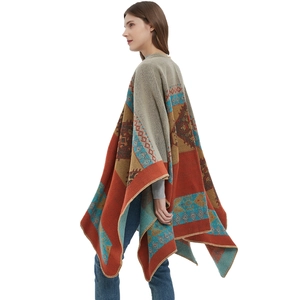 Thick orange jacquard knit poncho with bohemian geometric patterns and split hem design