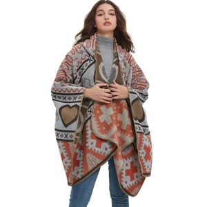 Knitted hooded poncho wrap featuring geometric heart patterns in grey and orange jacquard