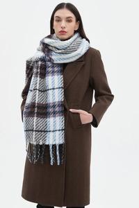 Detail of soft brushed plaid scarf featuring blue and brown check pattern with fringe