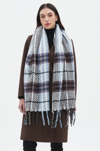 Detail shot of the long fringe and thick plaid fabric texture on a checkered scarf
