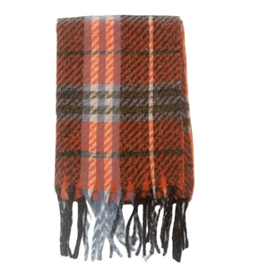 Close-up of classic orange and blue plaid scarf featuring soft knit texture and fringe