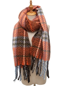 Detail of soft plaid scarf featuring orange check patterns and fringe trim on a mannequin