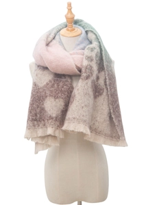 Detailed view of soft thick winter scarf with colorful heart patterns and fringe edges