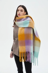 Detail of soft multi-color plaid scarf with long tassels in yellow, purple and blue