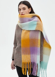 Close-up of thick winter scarf with large colorful checks and long fringe details