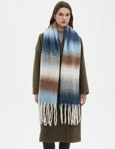 Detail shot of multi-color gradient scarf with thick yarn texture and long fringe tassels