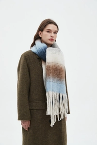 Detail of multi-color gradient striped scarf with thick fringe and plush wool texture