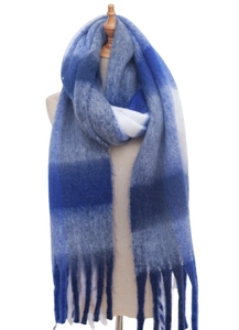 Close-up of thick knitted plaid scarf with gradient blue squares and long fringe detail