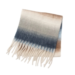 Detail of gradient knit scarf with boucle yarn fringe in beige grey and blue tones