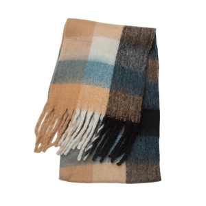 Close-up of thick plaid scarf featuring loop yarn texture and long fringe details