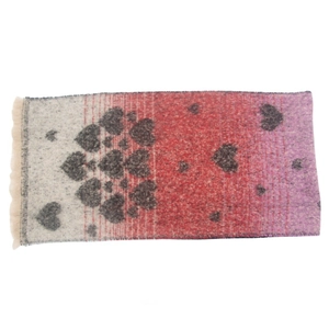 Detail of soft mohair-like knit scarf featuring heart pattern and elegant fringe tassels