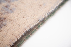 Macro detail of faux mohair knit scarf showing heart jacquard texture and fine stitching