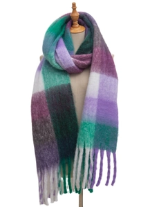Macro detail of thick plaid scarf with purple green patterns and soft fringed edges