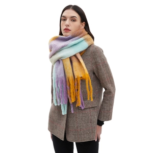 Colorful chunky knit plaid scarf with tassels for winter fashion shown on model