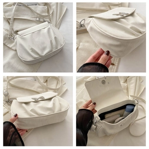 Detailed views of cream pleated crossbody bag featuring silver butterfly buckle and interior space