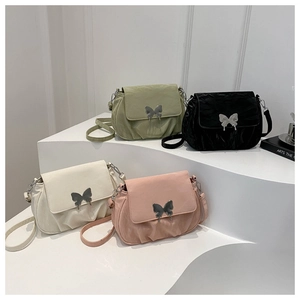 Close-up of stylish handbags in four colors featuring a silver butterfly clasp