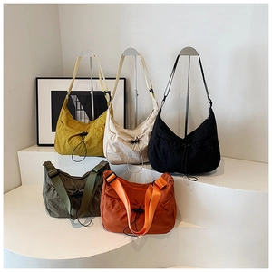Five assorted nylon crossbody tote bags in vibrant colors with wide fabric straps