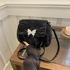 Fashionable black pleated shoulder bag with a silver butterfly clasp and slim strap