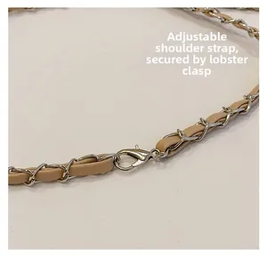 Detail of adjustable chain shoulder strap with silver lobster clasp on a quilted bag
