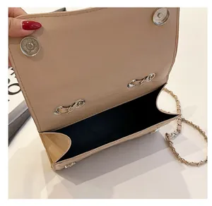 Detail view of the beige quilted bag interior featuring a dual magnetic closure system