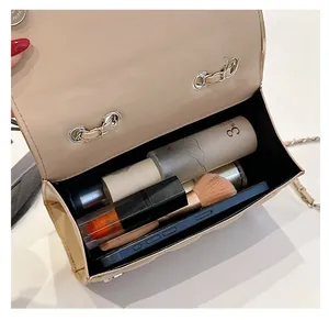 Interior view showing large capacity for phone and cosmetics in beige quilted bag