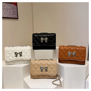 Quilted chain bags in four colors featuring elegant metal bow clasps and sleek textures