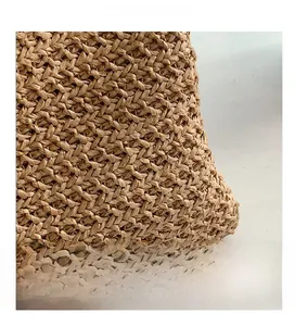 Detailed macro view of woven straw material showing high-quality raffia texture and pattern