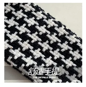 Macro detail of houndstooth woven fabric with metallic thread for the handbag handle
