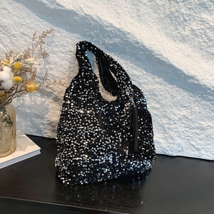 Sparkly black sequin tote bag with a crescent shape and starry metallic shimmer