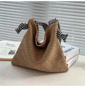 Close-up of woven straw handbag with houndscut check ribbon wrap handle and detail