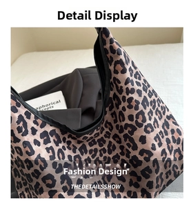 Close-up of leopard print tote bag fabric with black piping and textile texture detail