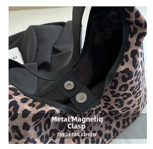Close-up of leopard print shoulder bag featuring a durable magnetic metal button closure