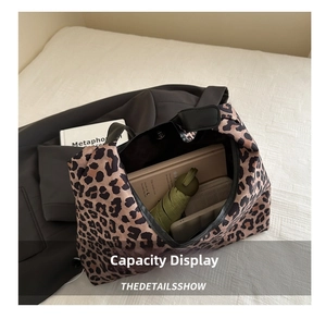 Leopard print tote bag interior showing capacity for umbrella, wallet, and phone