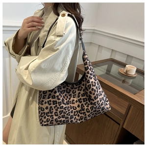 Grand sac fourre-tout léopard porté à l'épaule avec un trench beige pour l'automne