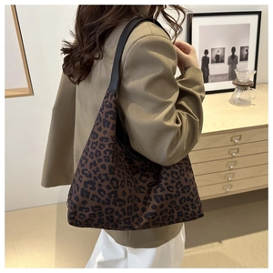 Detail of leopard print canvas bag with wide shoulder strap in home setting
