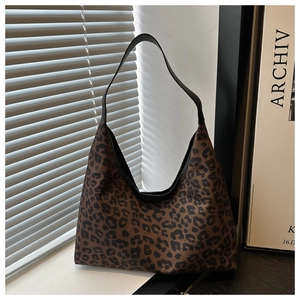 Detail of leopard print hobo bag showing soft suede texture and black shoulder strap