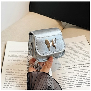 Détail du mini sac argenté miroir avec fermoir papillon et fine bandoulière chaîne