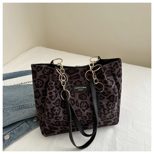 Detail of leopard print tote bag featuring metallic chain strap and suede-like fabric texture