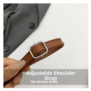 Close-up of brown leather adjustable shoulder strap with silver metal buckle detail
