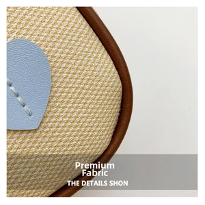 Macro detail of yellow woven fabric with blue heart patch and leather piping trim
