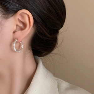 Elegant silver twisted rope hoop earring shown on model for a stylish vintage look