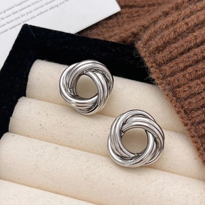 Modern silver multi-loop knotted stud earrings in a luxury display jewelry box