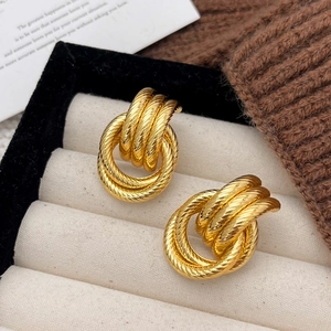 Golden vintage textured twisted rope hoop earrings displayed on a soft velvet jewelry box
