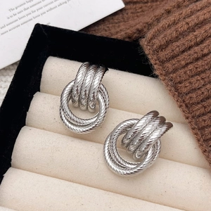 Detail view of silver twisted hoop earrings showcased in a premium jewelry gift box