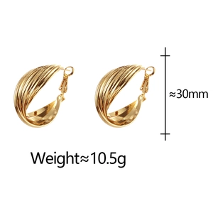 Macro shot of gold layered hoop earrings measuring 30mm with weight specifications