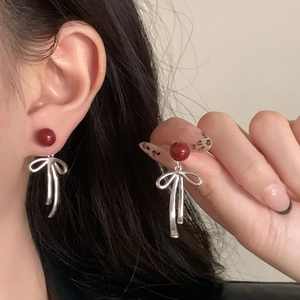 Elegant gold-plated bow earrings with red cinnabar beads for a vintage feminine style