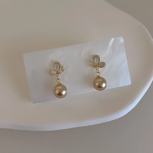 Elegant gold butterfly earrings with sparkling crystals and premium champagne pearls