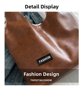 Close-up of brown faux leather tote bag with FASHION label and soft texture detail
