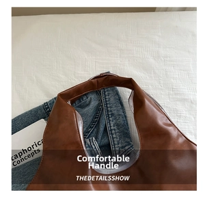 Close-up of brown PU leather handbag handle showing expert stitching and curved design