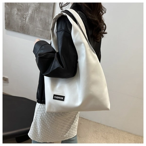 Detailed view of a white large PU leather hobo bag with Fashion tag worn by a model